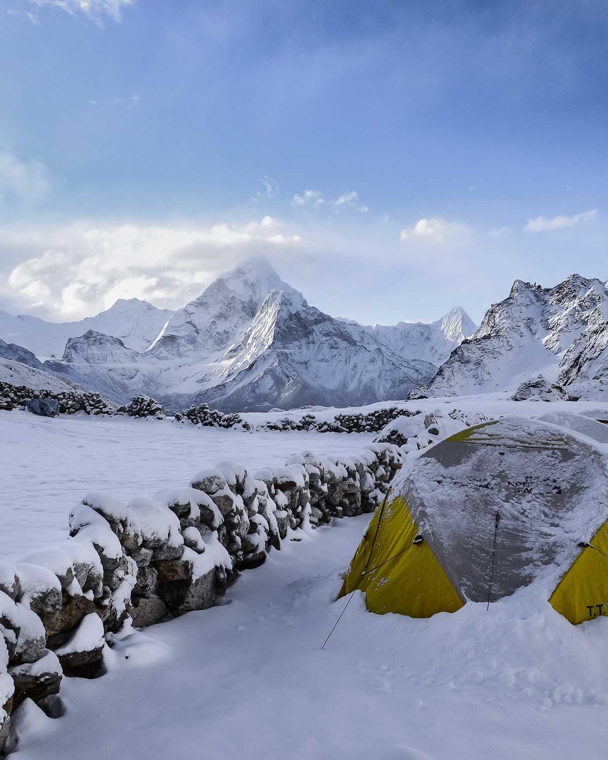 A still lake under snow-covered peaks.